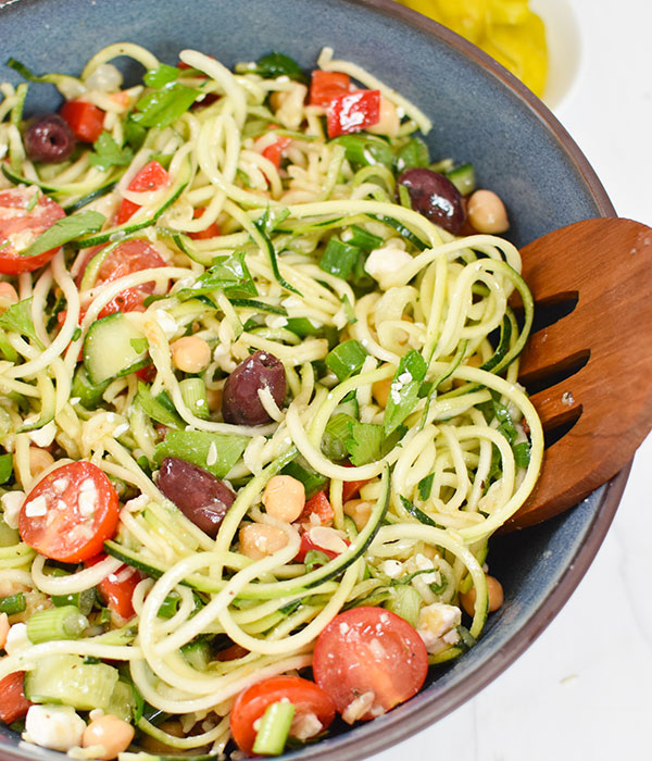 Mediterranean Zucchini Pasta Salad with spiraled zuchini, cucumber, tomato, pepper, feta, and chickpeas