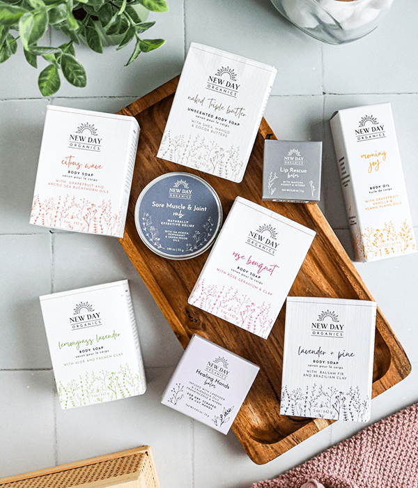A Top-Down Image of an Assortment of New Day Organics Products on a Wood Serving Tray