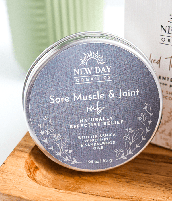 A Container of New Day Organics Sore Muscle and Joint Rub