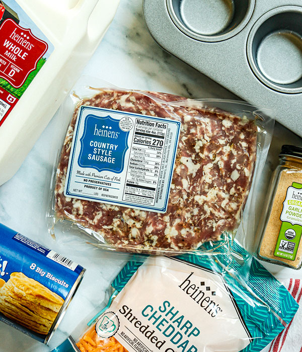 Heinen's Country Style Sausage, Sharp Cheddar, Whole Milk, Garlic Powder, Biscuit dough, and muffin tin