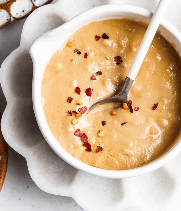 A Small Bowl of Tahini with a Spoon